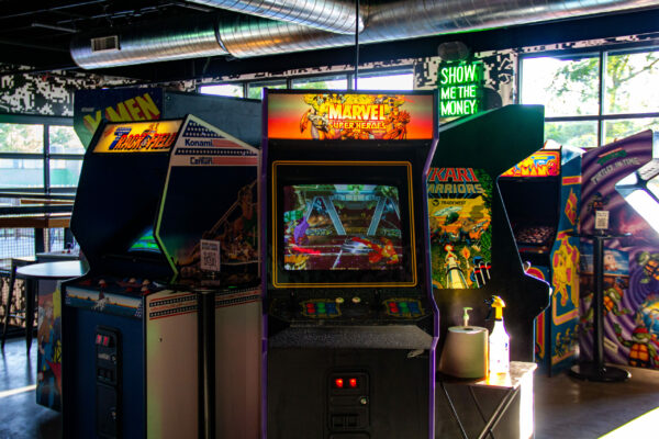 Query successful A wide shot of several colorful arcade machines lined up inside a bar. Query successful A wide shot of several colorful arcade machines lined up inside a bar.