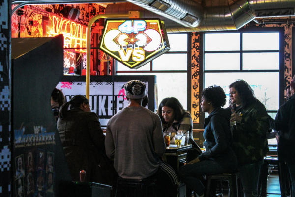 A diverse group of people enjoying drinks and conversation at a lively bar setting A diverse group of people enjoying drinks and conversation at a lively bar setting