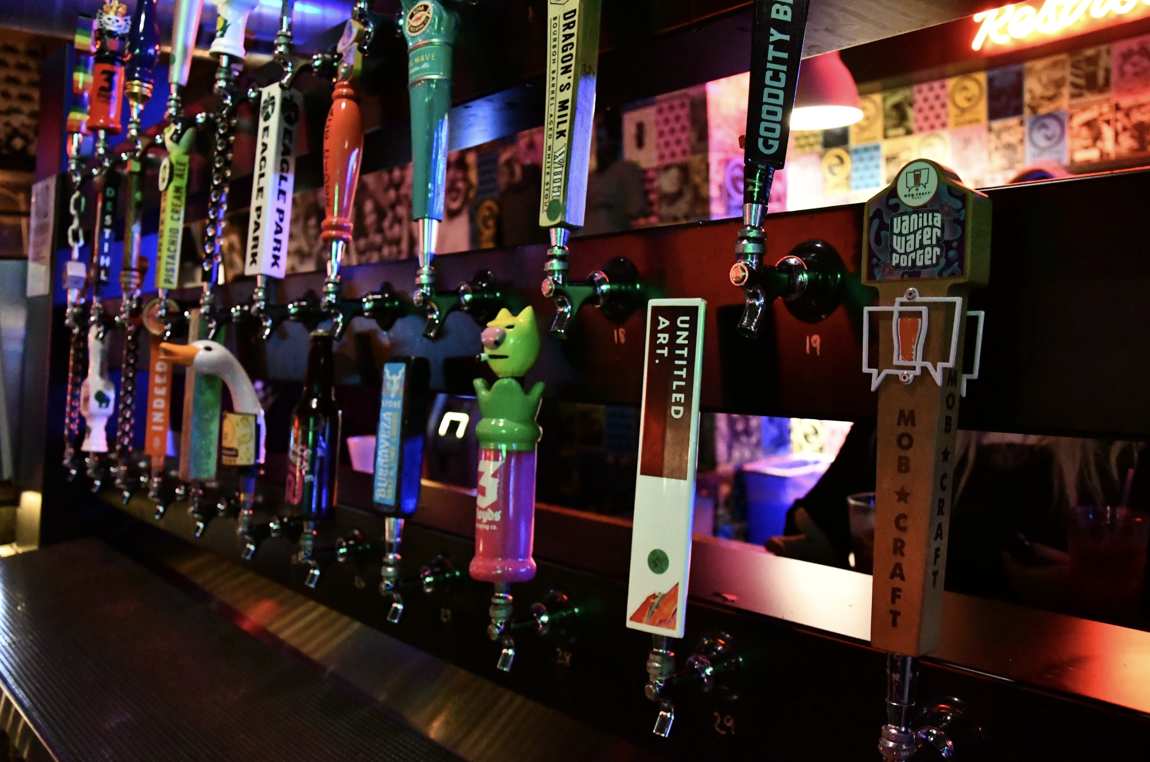 A bar scene showcasing an array of beer taps and different beer options available for customers