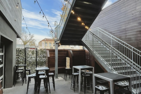 The patio at The New Yorker in San Francisco, featuring outdoor seating and greenery in a vibrant urban setting The patio at The New Yorker in San Francisco, featuring outdoor seating and greenery in a vibrant urban setting