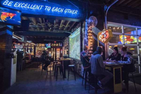 A rustic bar with a wooden counter, surrounded by ocean views, evoking a sense of adventure at the world's edge A rustic bar with a wooden counter, surrounded by ocean views, evoking a sense of adventure at the world's edge